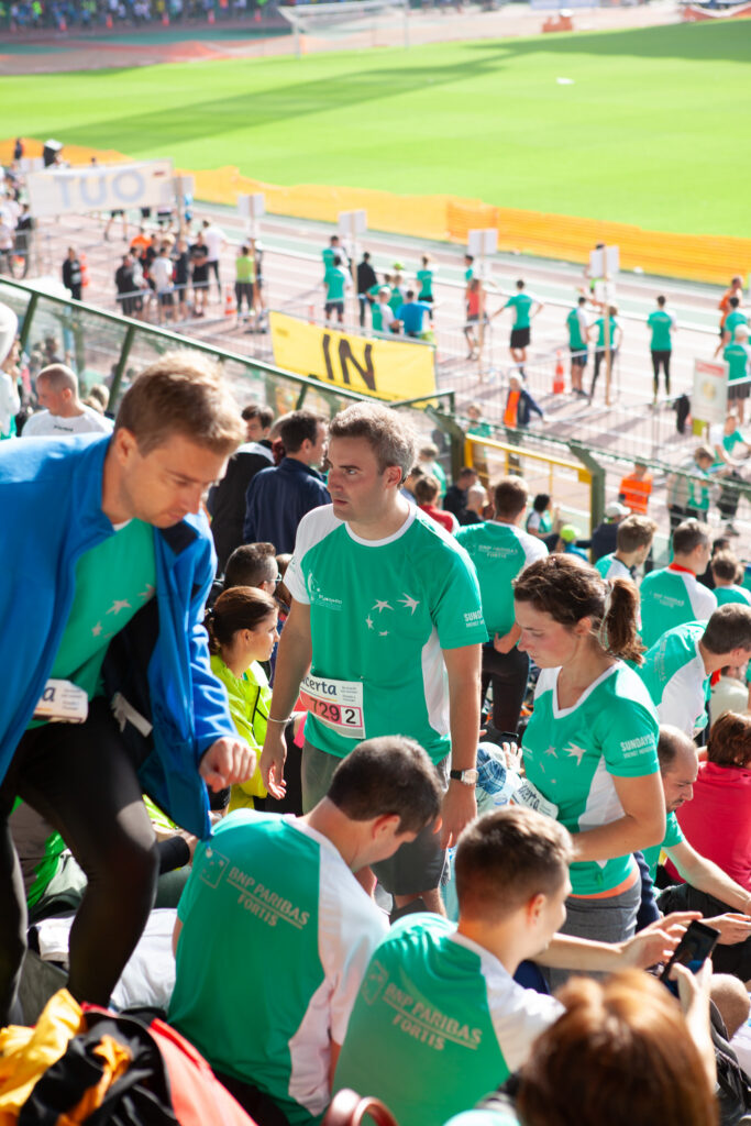 Vue d’ensemble d’un événement professionnel corporate et sportif avec participants réunis dans un stade en plein air